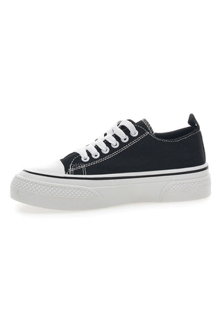 Schwarze Canvas-Sneaker im Café kosten 210